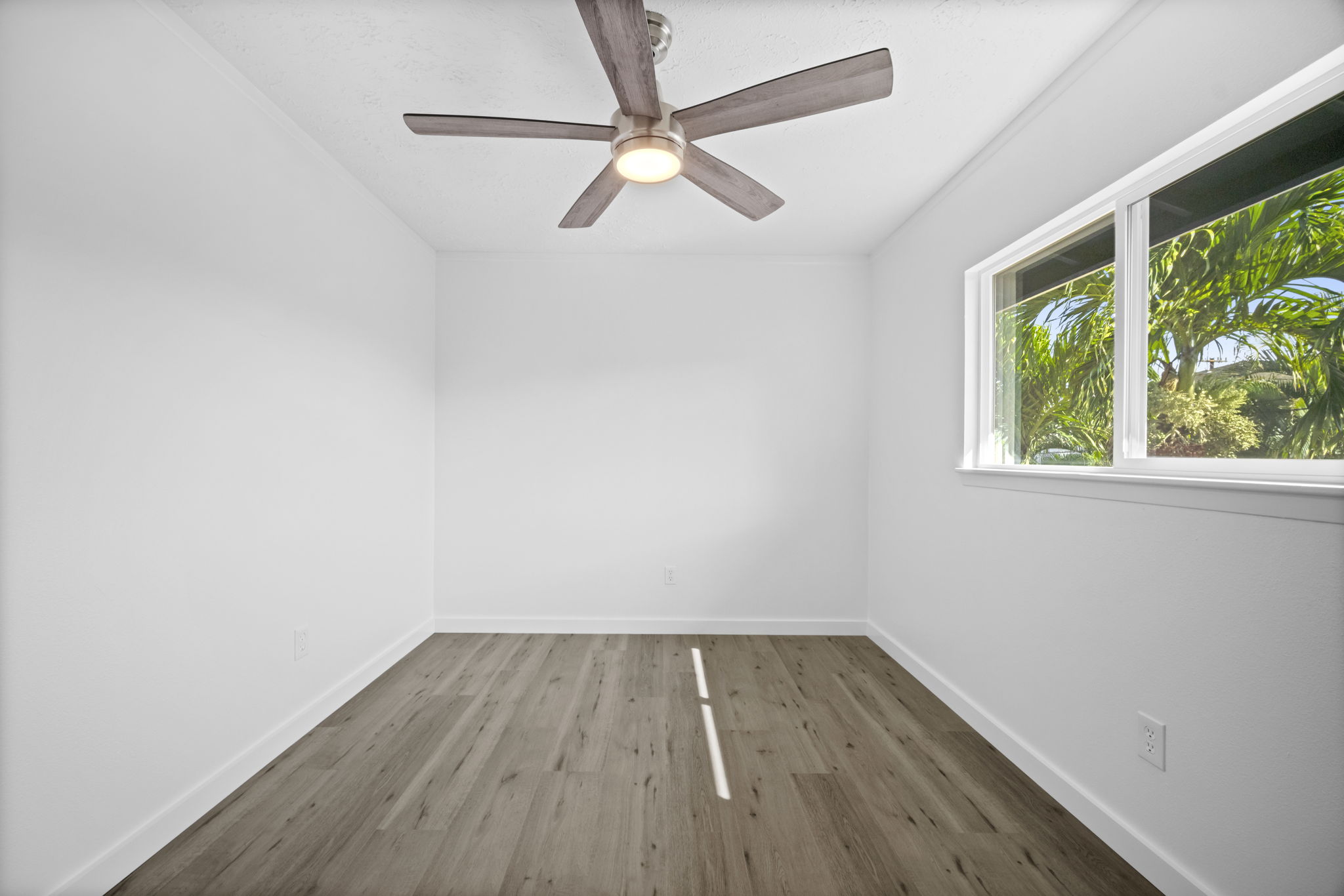 4431 Iona Road Hanapepe, HI 96705 - Photo 12 of 20 a view of a room with wooden floor fan and a window