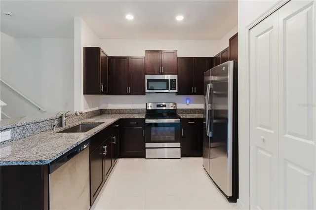 an empty room with chandelier fan