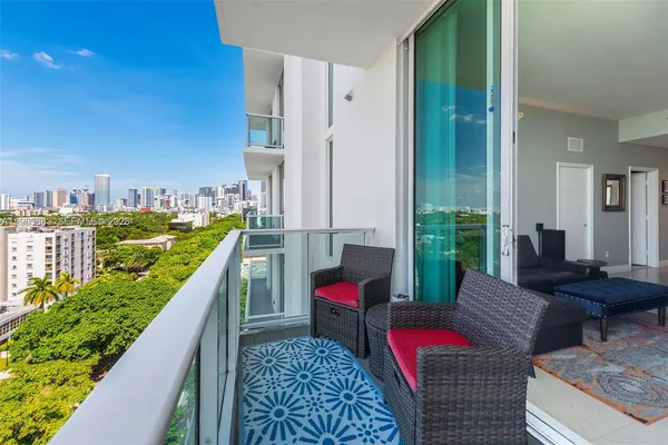 a balcony with chairs and a table