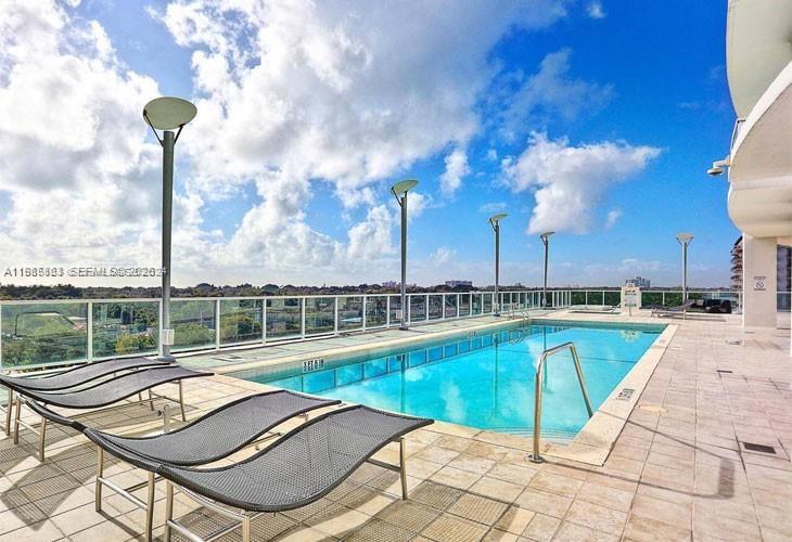 2525 Southwest 3rd Avenue, Unit 906 Miami, FL 33129 - Photo 19 of 23 a view of a swimming pool with a lounge chairs
