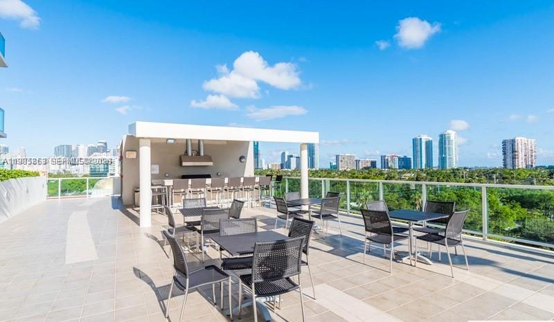 2525 Southwest 3rd Avenue, Unit 906 Miami, FL 33129 - Photo 21 of 23 a view of a terrace with furniture and garden