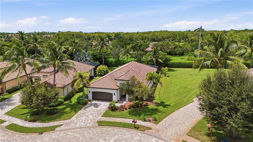 9479 Piacere Way Naples, FL 34113 - Photo 42 of 48 Mediterranean-inspired architecture with a tile roof, an integrated garage, and a paver driveway
