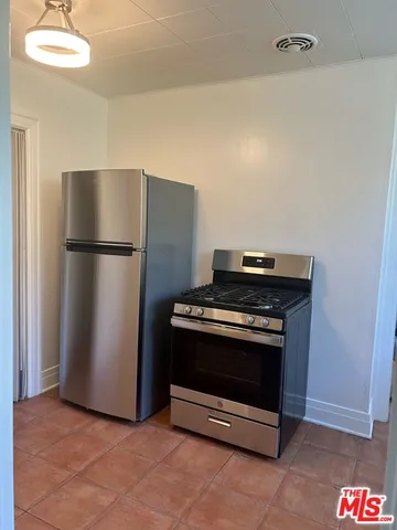 a kitchen with a stove and a refrigerator