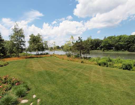 Undisclosed Address Darien, CT 06820 - Photo 20 of 20 a view of a lake with houses in the back