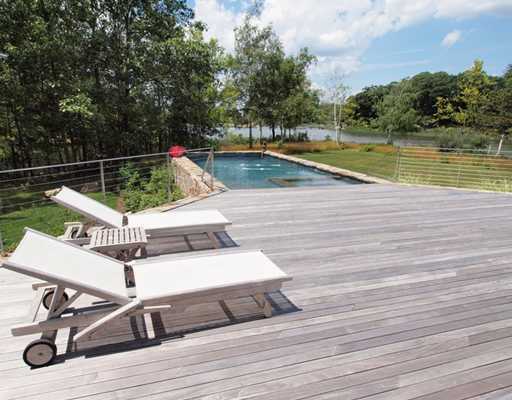 Undisclosed Address Darien, CT 06820 - Photo 4 of 20 a view of swimming pool with lounge chair and wooden fence