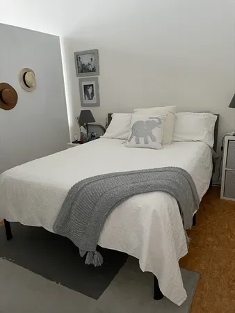 a bedroom with a bed and wall painting