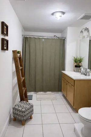 a bathroom with a sink a toilet a mirror and vanity