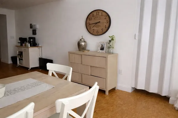 a view of a kitchen with a table and chairs
