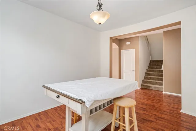 a view of a hallway with wooden floor and entryway
