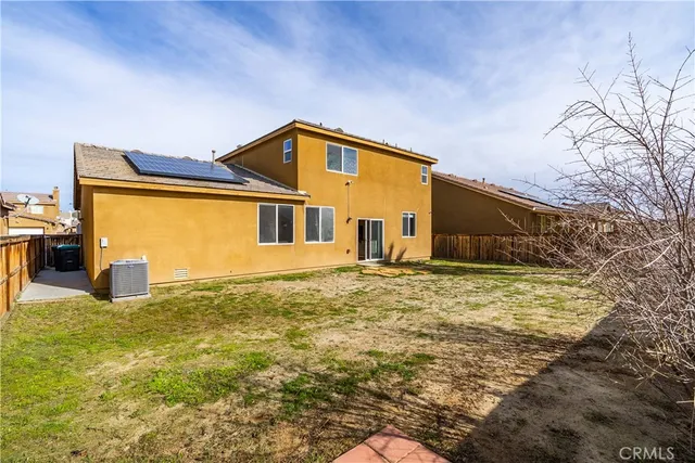a front view of a house with yard and seating area