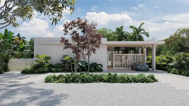 a front view of a house with a yard and potted plants