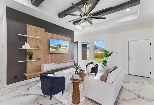 a living room with furniture a chandelier and a window
