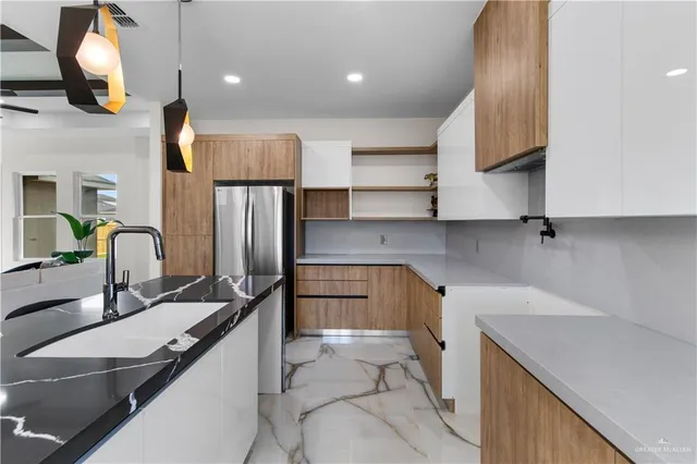 a kitchen with a sink and refrigerator