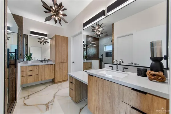 a spacious bathroom with a granite countertop sink a mirror and a