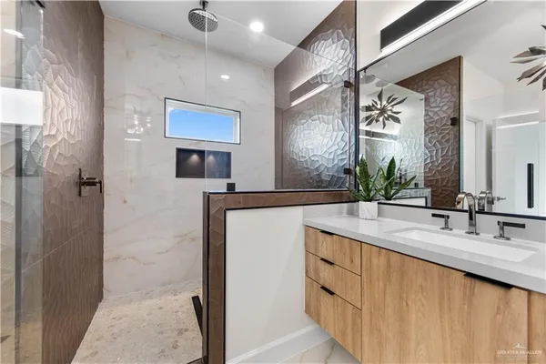 a bathroom with a double vanity sink a mirror and a shower