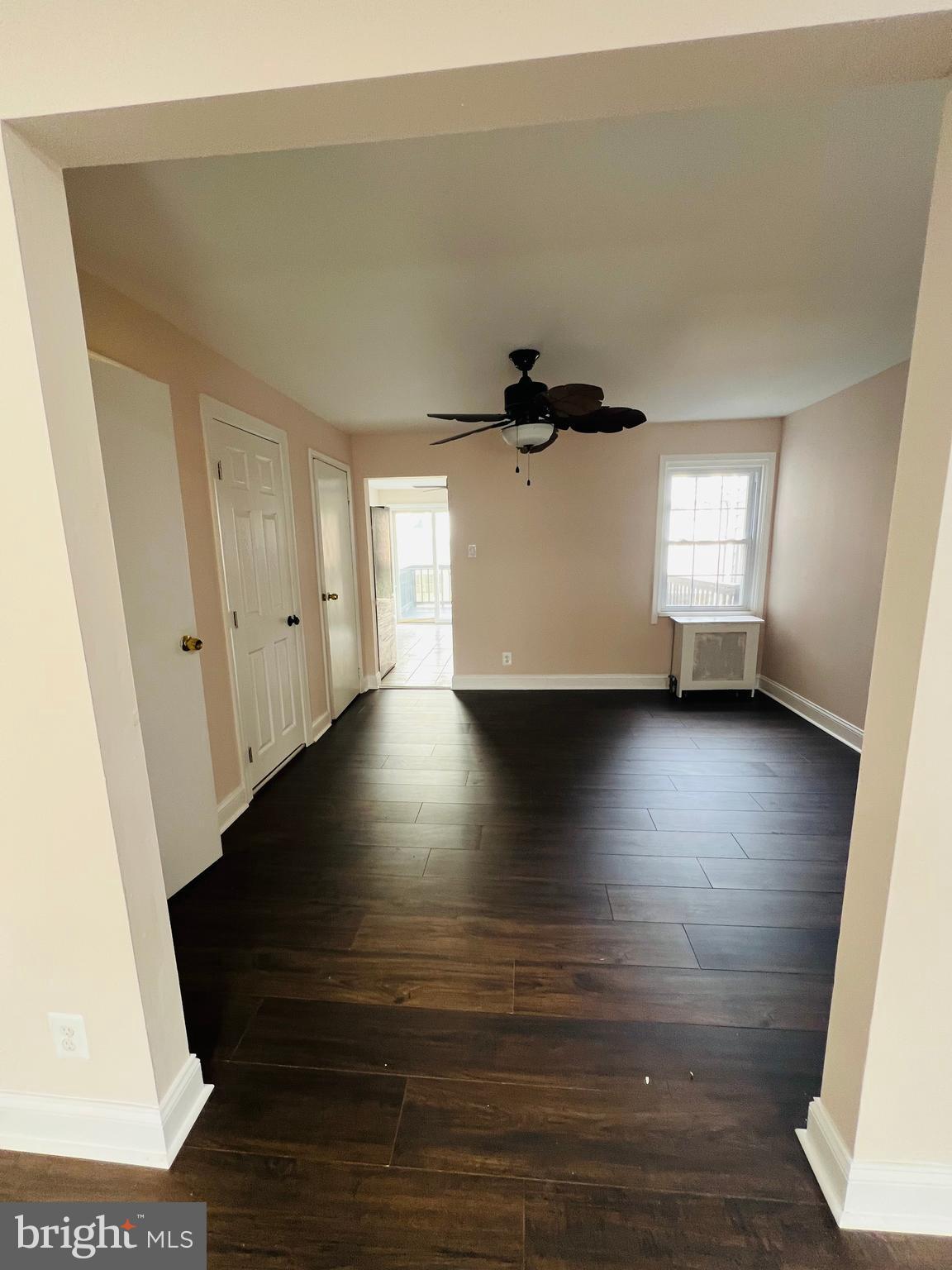 223 Maypole Road Upper Darby, PA 19082 - Photo 11 of 48 an empty room with wooden floor and windows