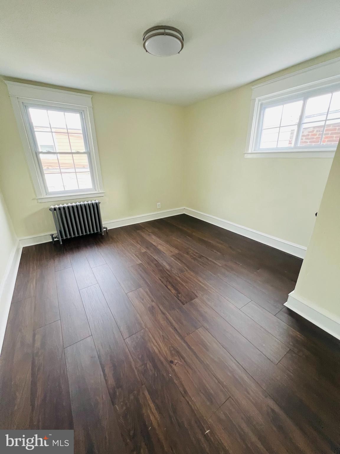 223 Maypole Road Upper Darby, PA 19082 - Photo 12 of 48 an empty room with wooden floor and windows