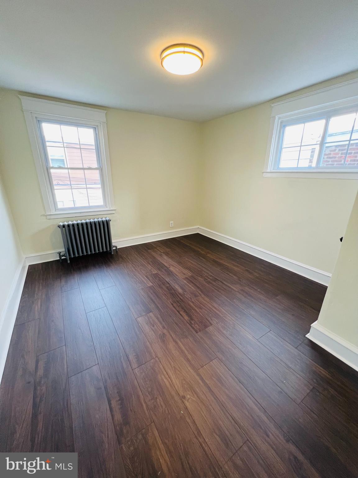 223 Maypole Road Upper Darby, PA 19082 - Photo 13 of 48 an empty room with wooden floor and windows