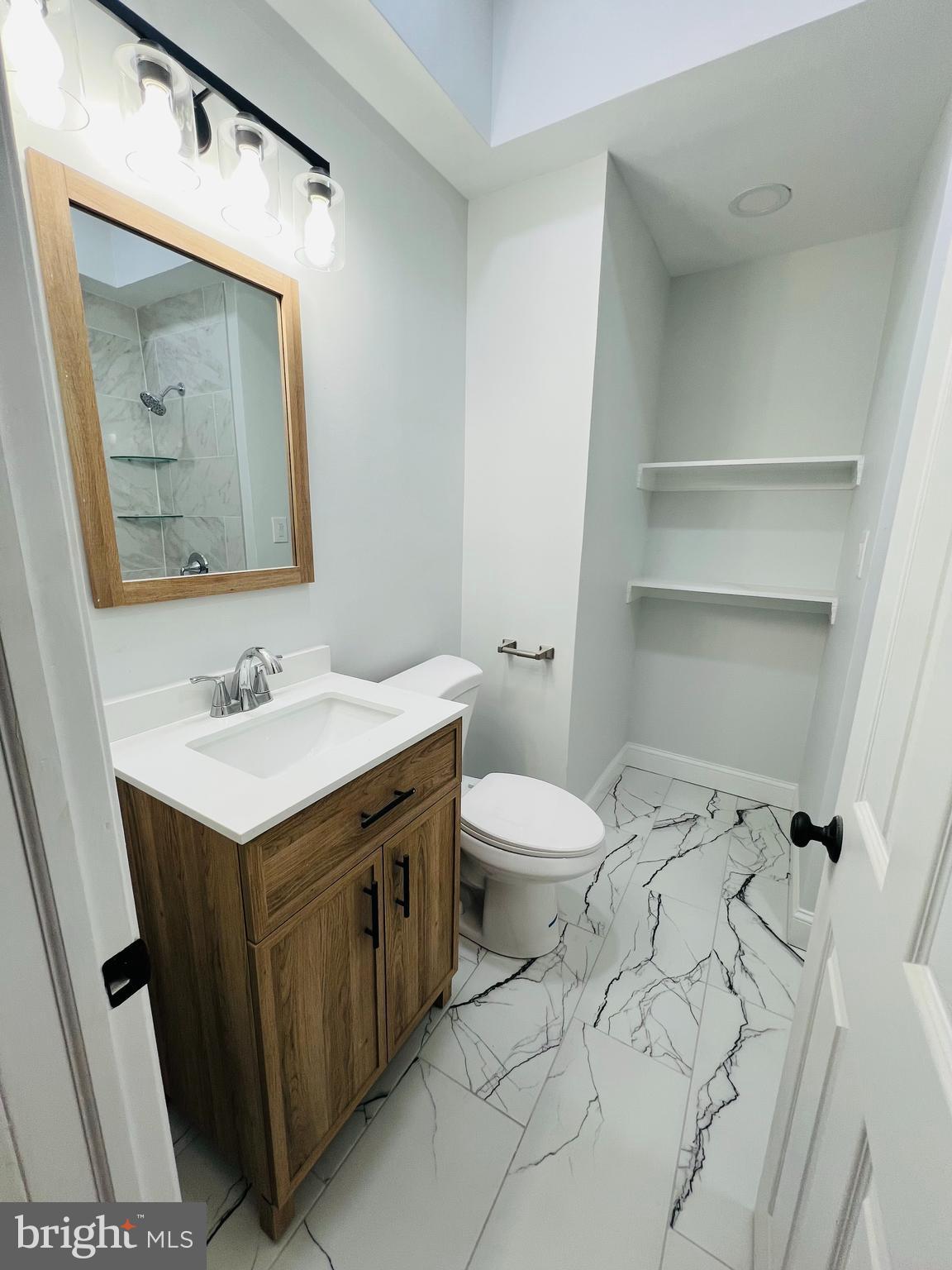 223 Maypole Road Upper Darby, PA 19082 - Photo 17 of 48 a bathroom with a sink vanity mirror and toilet