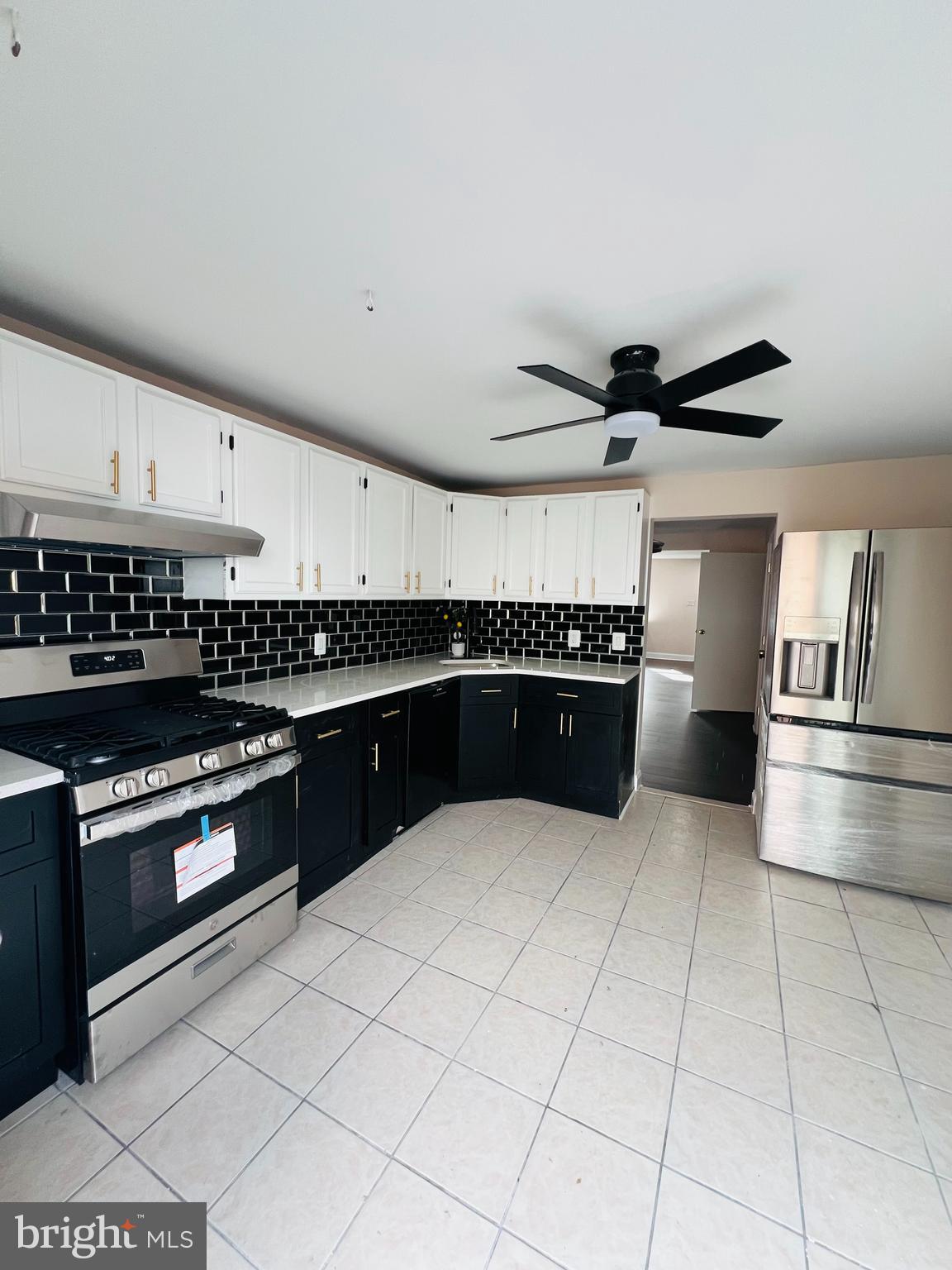223 Maypole Road Upper Darby, PA 19082 - Photo 22 of 48 a kitchen with stainless steel appliances granite countertop a stove and a refrigerator