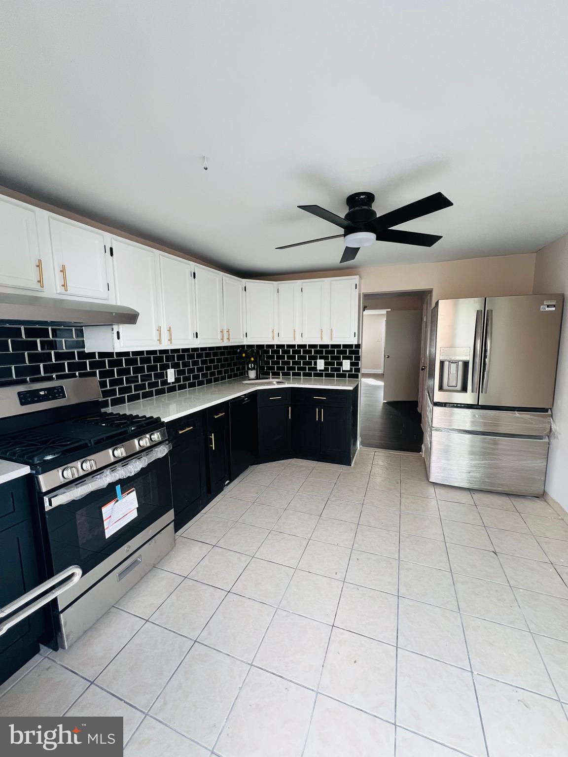 223 Maypole Road Upper Darby, PA 19082 - Photo 24 of 48 a kitchen with granite countertop a refrigerator and a sink