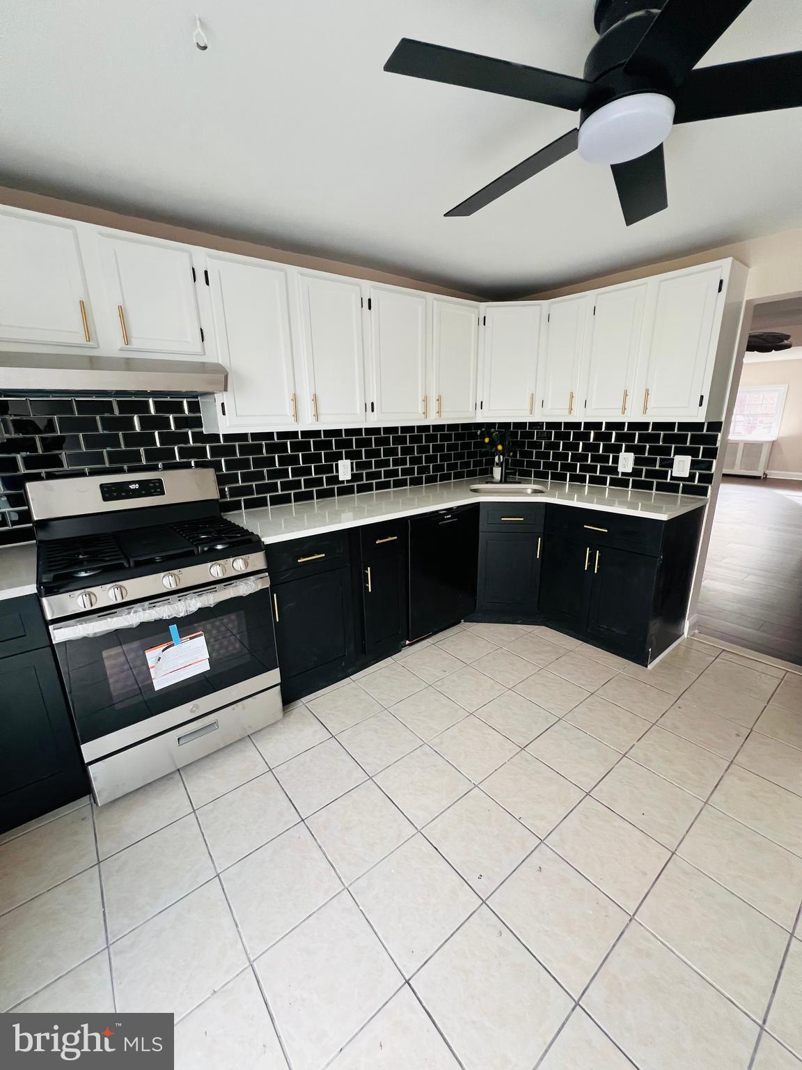 223 Maypole Road Upper Darby, PA 19082 - Photo 25 of 48 a kitchen with stainless steel appliances a sink and a stove