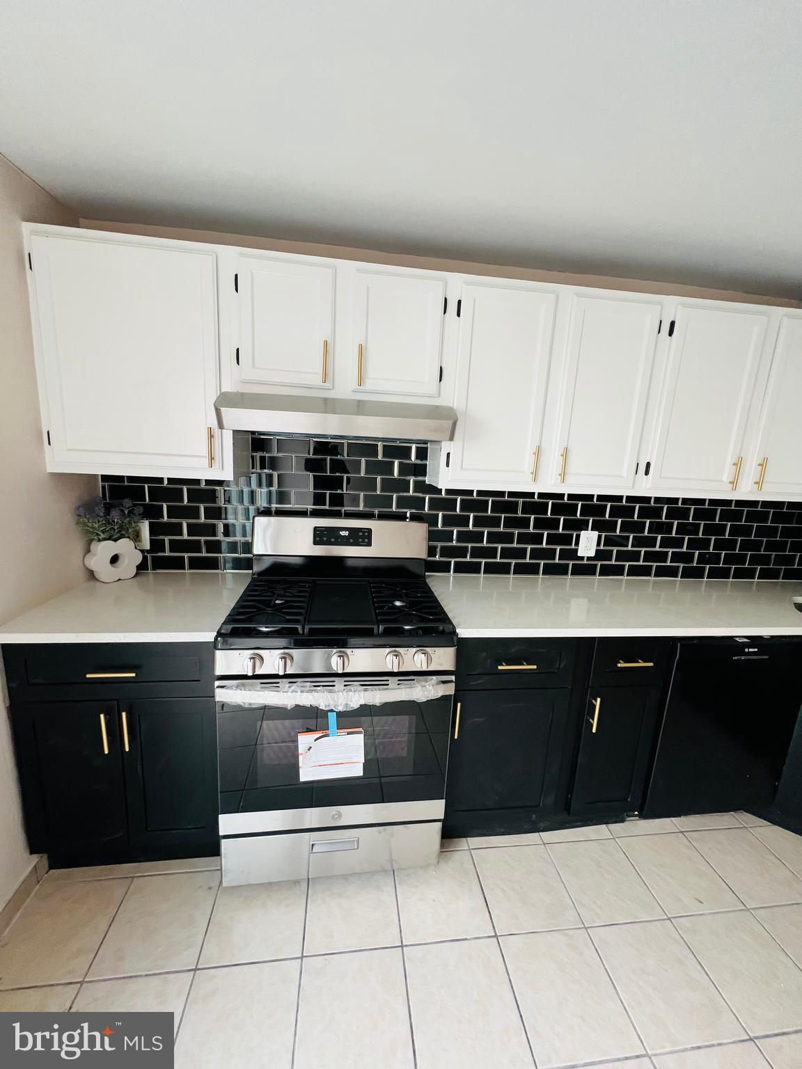 223 Maypole Road Upper Darby, PA 19082 - Photo 27 of 48 a kitchen with a stove a sink and cabinets