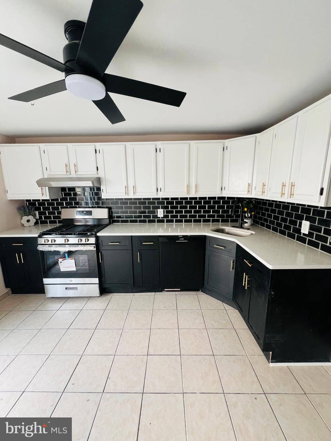 223 Maypole Road Upper Darby, PA 19082 - Photo 28 of 48 a kitchen with a sink a stove and cabinets