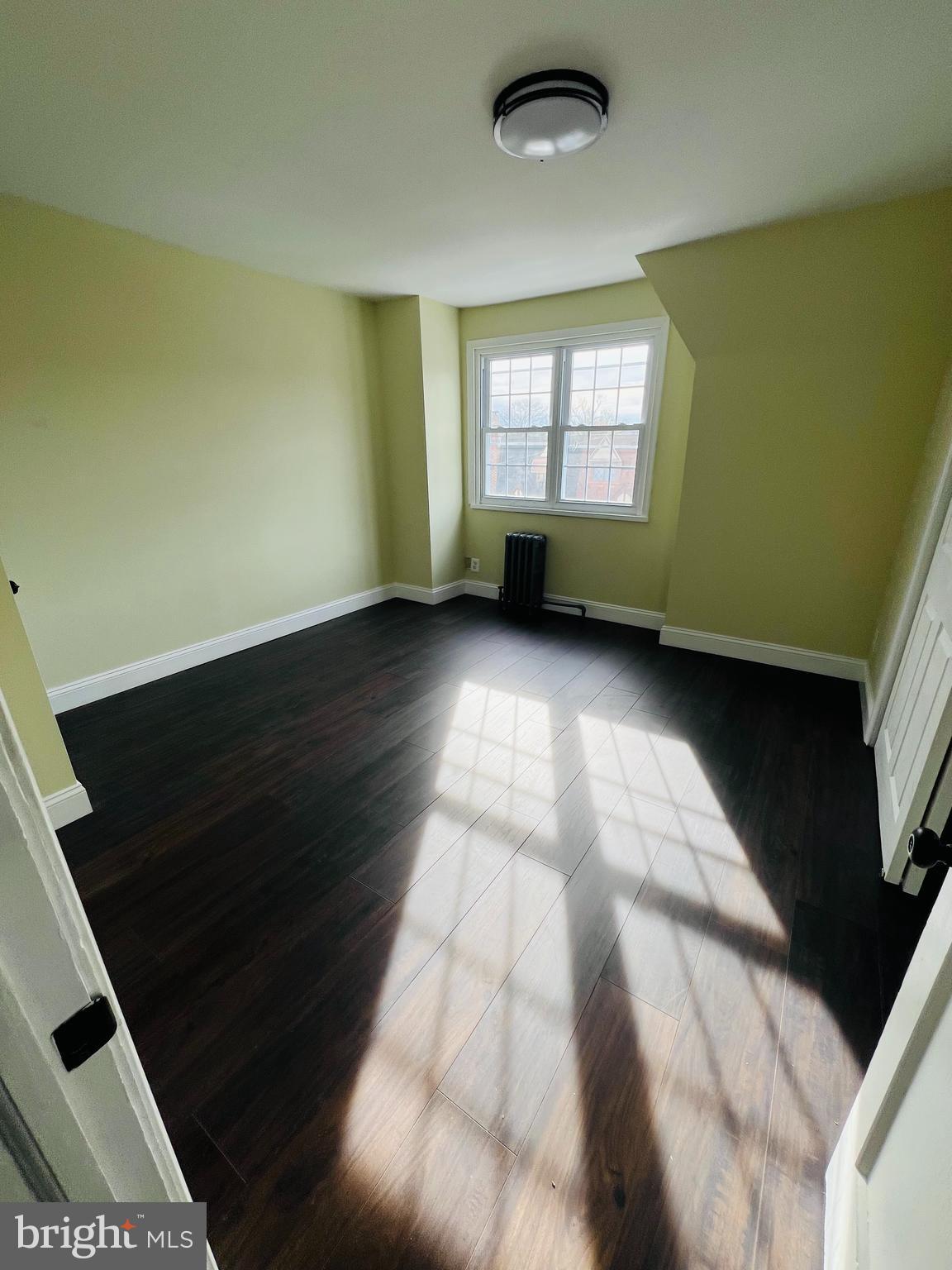 223 Maypole Road Upper Darby, PA 19082 - Photo 8 of 48 a view of an empty room with a window and wooden floor