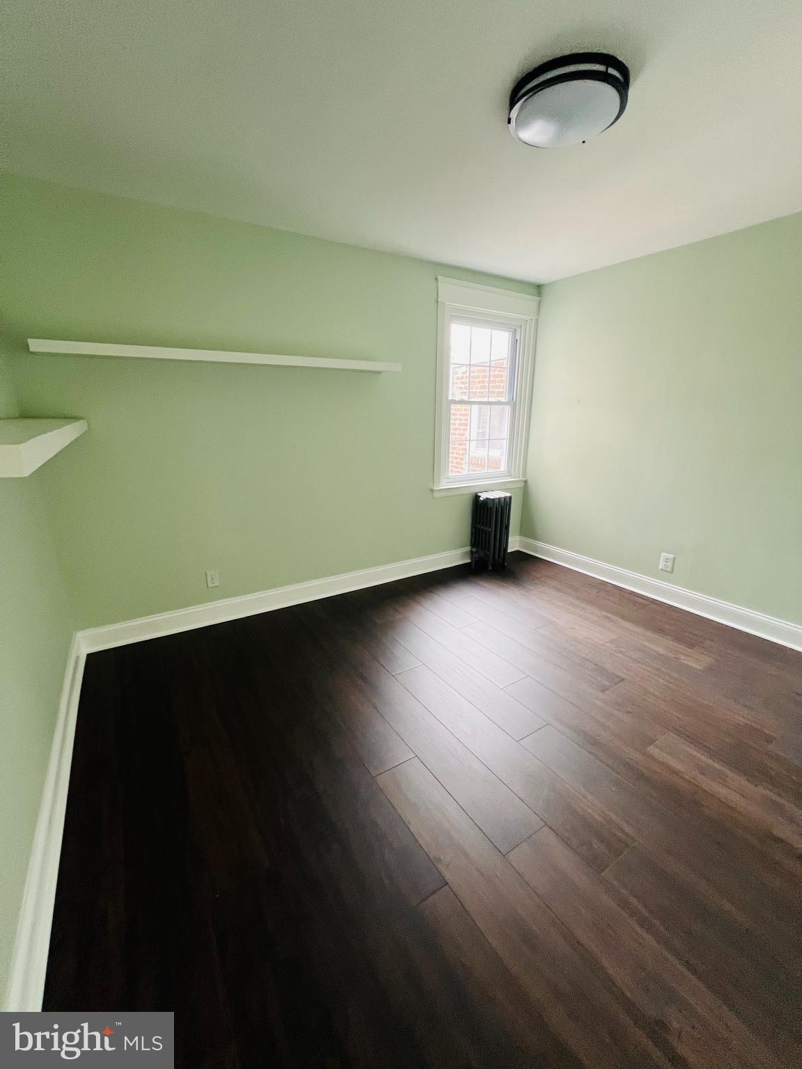 223 Maypole Road Upper Darby, PA 19082 - Photo 9 of 48 an empty room with wooden floor and windows