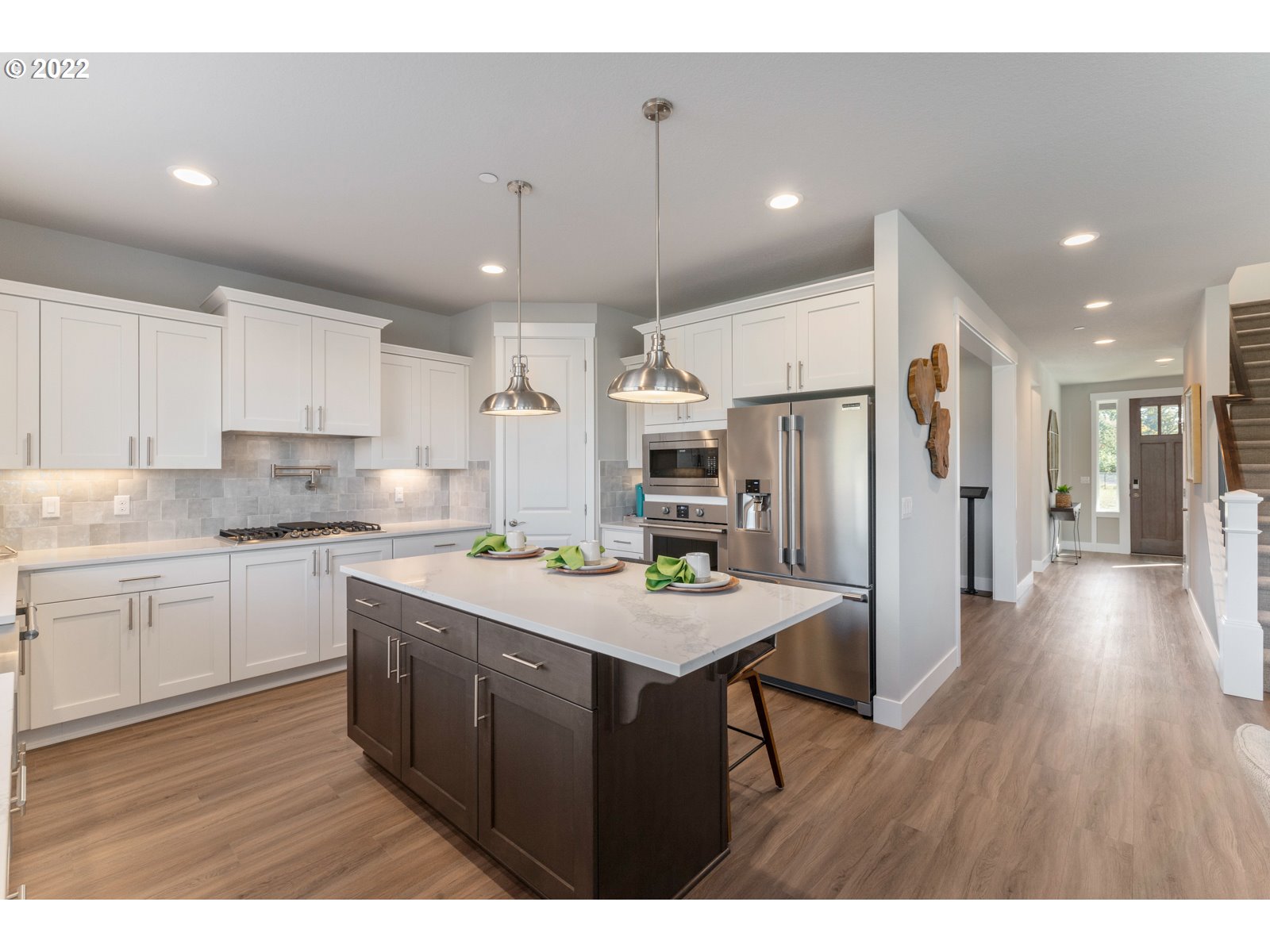 5657 North 92nd Avenue Camas, WA 98607 - Photo 11 of 32 a kitchen with refrigerator cabinets and wooden floor