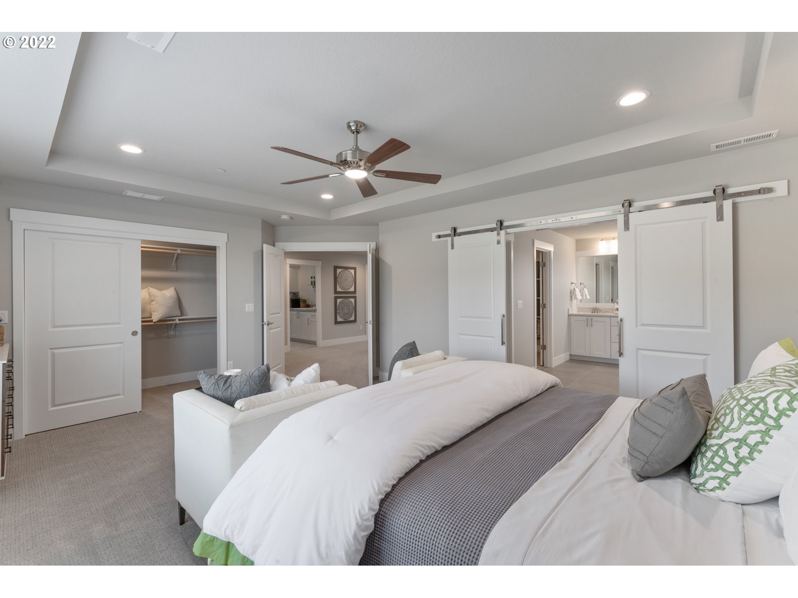5657 North 92nd Avenue Camas, WA 98607 - Photo 25 of 32 a bedroom with a large bed and a chandelier