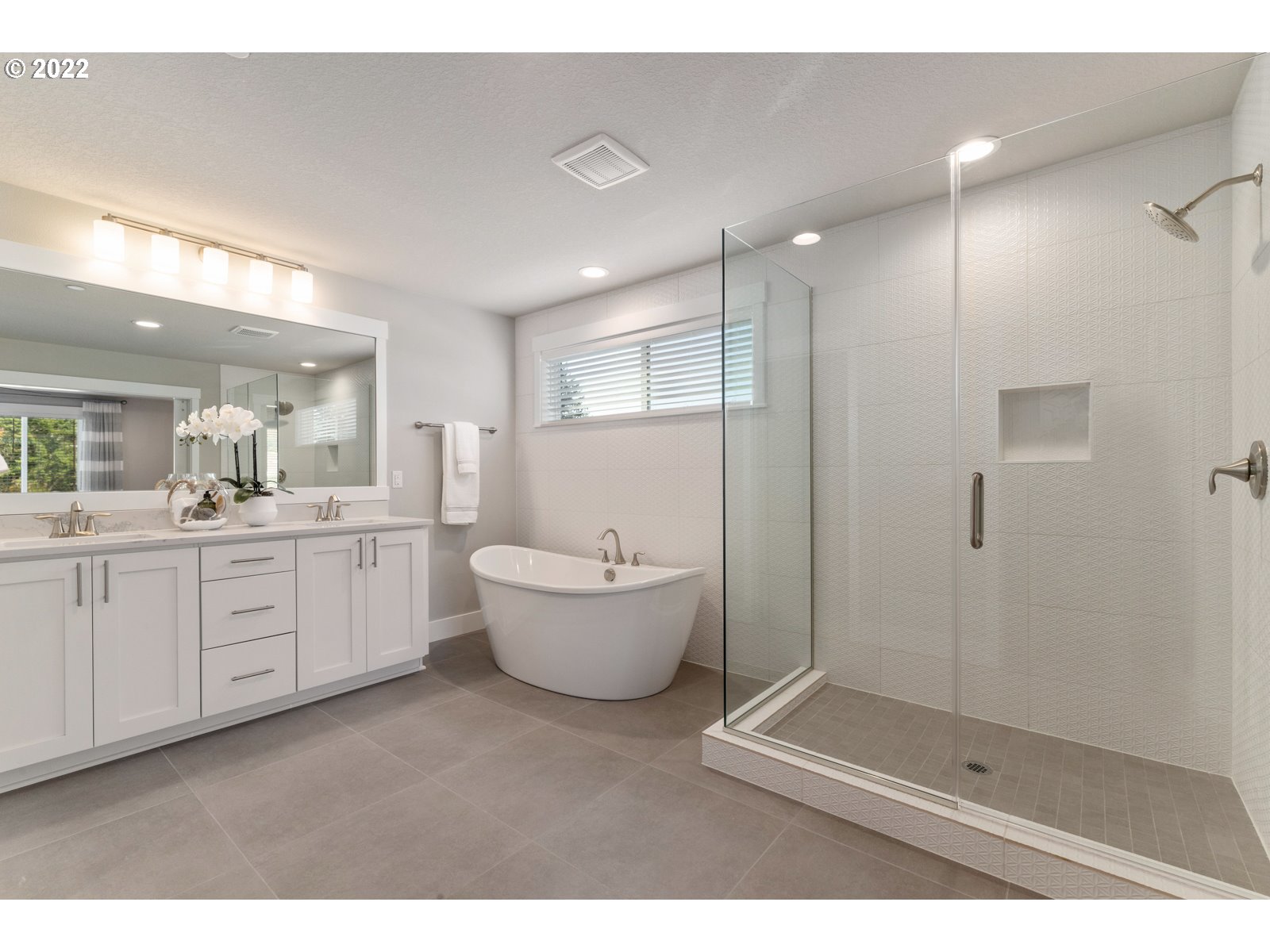 5657 North 92nd Avenue Camas, WA 98607 - Photo 28 of 32 a spacious bathroom with a double vanity sink a large mirror and shower
