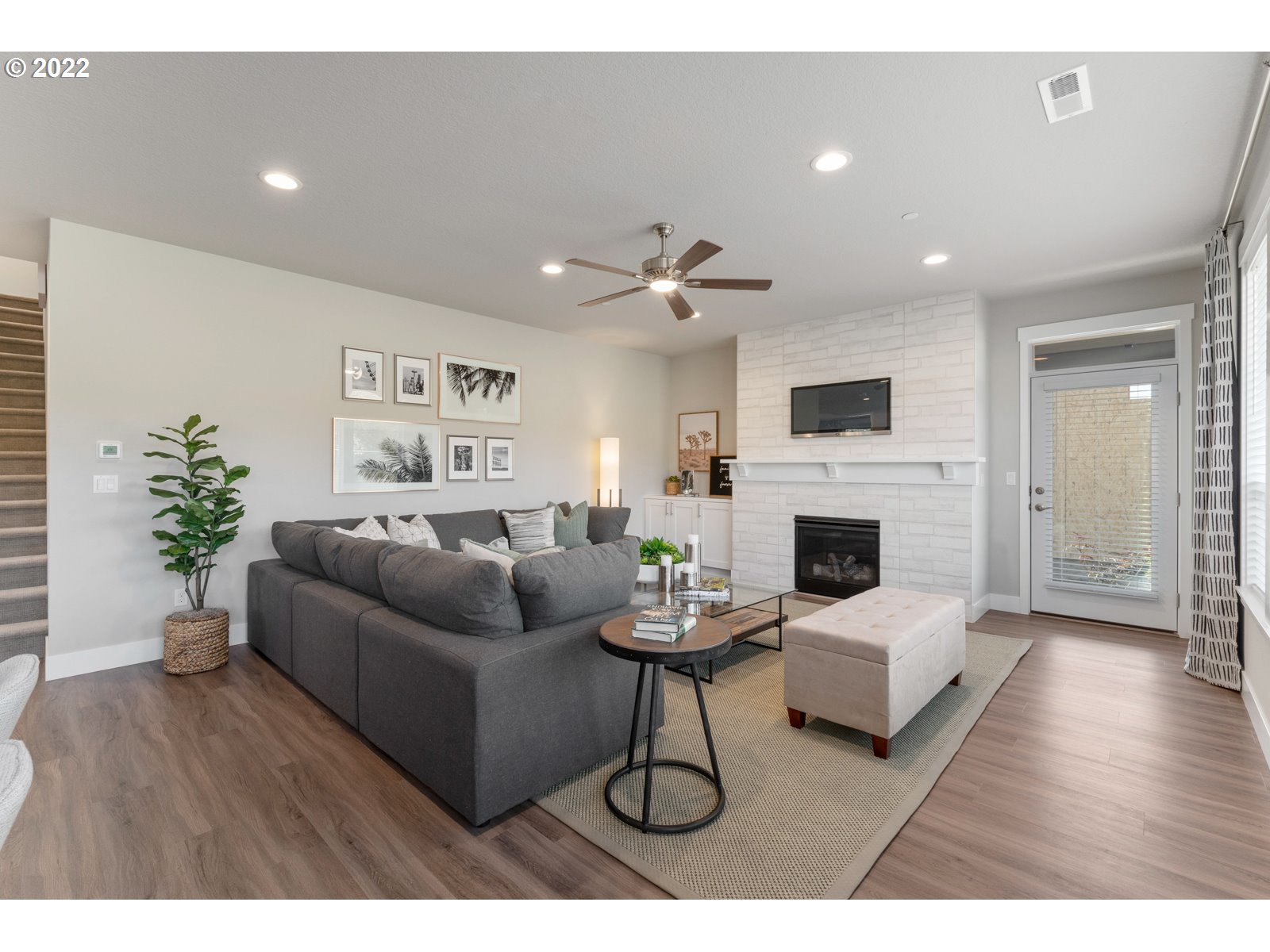 5657 North 92nd Avenue Camas, WA 98607 - Photo 6 of 32 a living room with furniture a fireplace and a potted plant