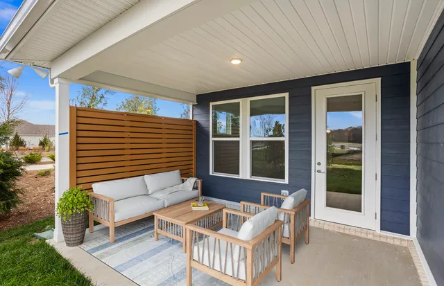 an empty room with wooden floor and entrance