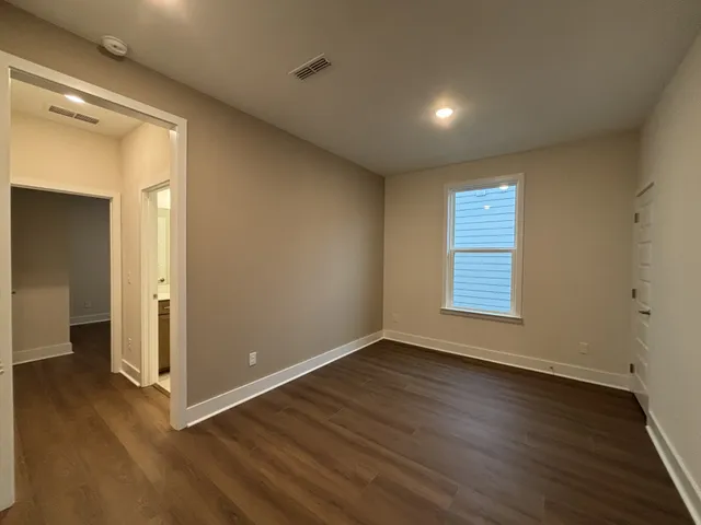 a dining room with furniture large windows and a rug
