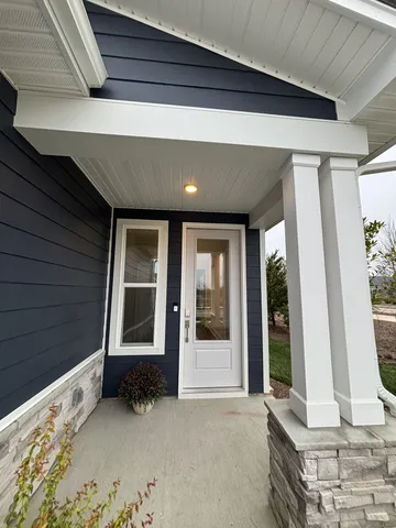a kitchen with stainless steel appliances kitchen island granite countertop a sink refrigerator and cabinets