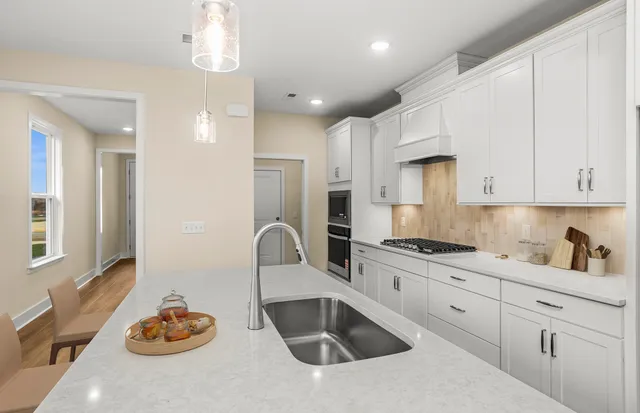 a kitchen with kitchen island a sink appliances and a counter top space