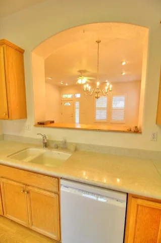 a view of a kitchen with a sink and wooden floor