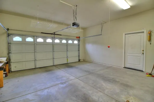 a flower vase with flowers and wooden floor