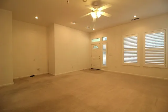 an empty room with a empty space and a ceiling fan