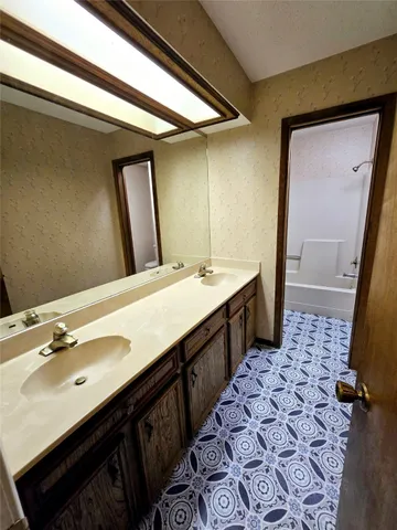 a bathroom with a double vanity sink a and mirror