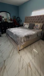 a bedroom with bed and mirror