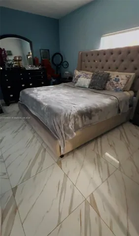 a bedroom with bed and mirror