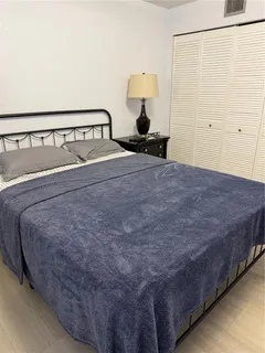 a bed sitting in a bedroom and table
