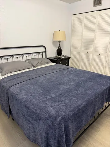 a bed sitting in a bedroom and table