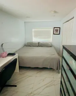 a bedroom with a bed and a desk