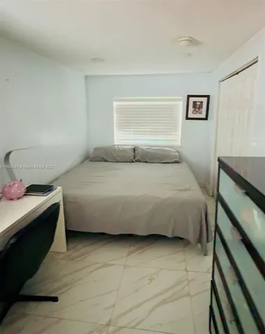 a bedroom with a bed and a desk