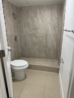 a bathroom with a toilet and a shower
