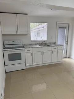 a kitchen with stainless steel appliances granite countertop a sink and a stove top oven